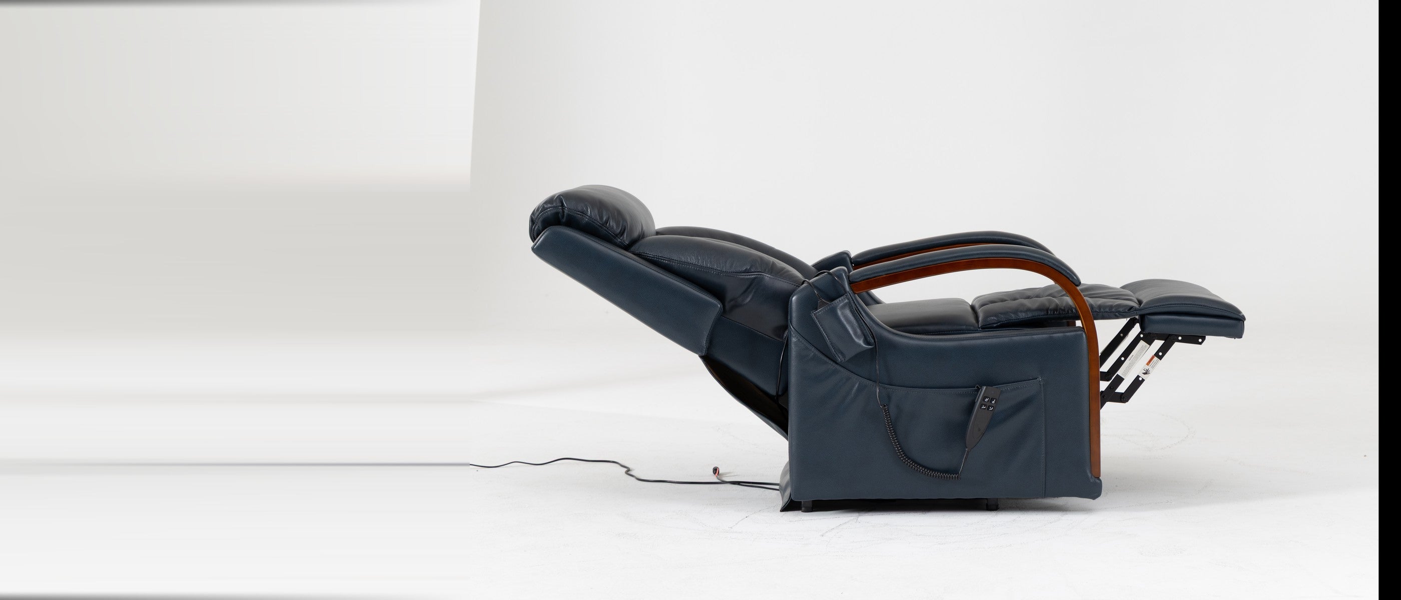 Irene House 9185 small power lift recliner in dark blue top grain leather, reclined from the side with the footrest raised and solid wood arms visible