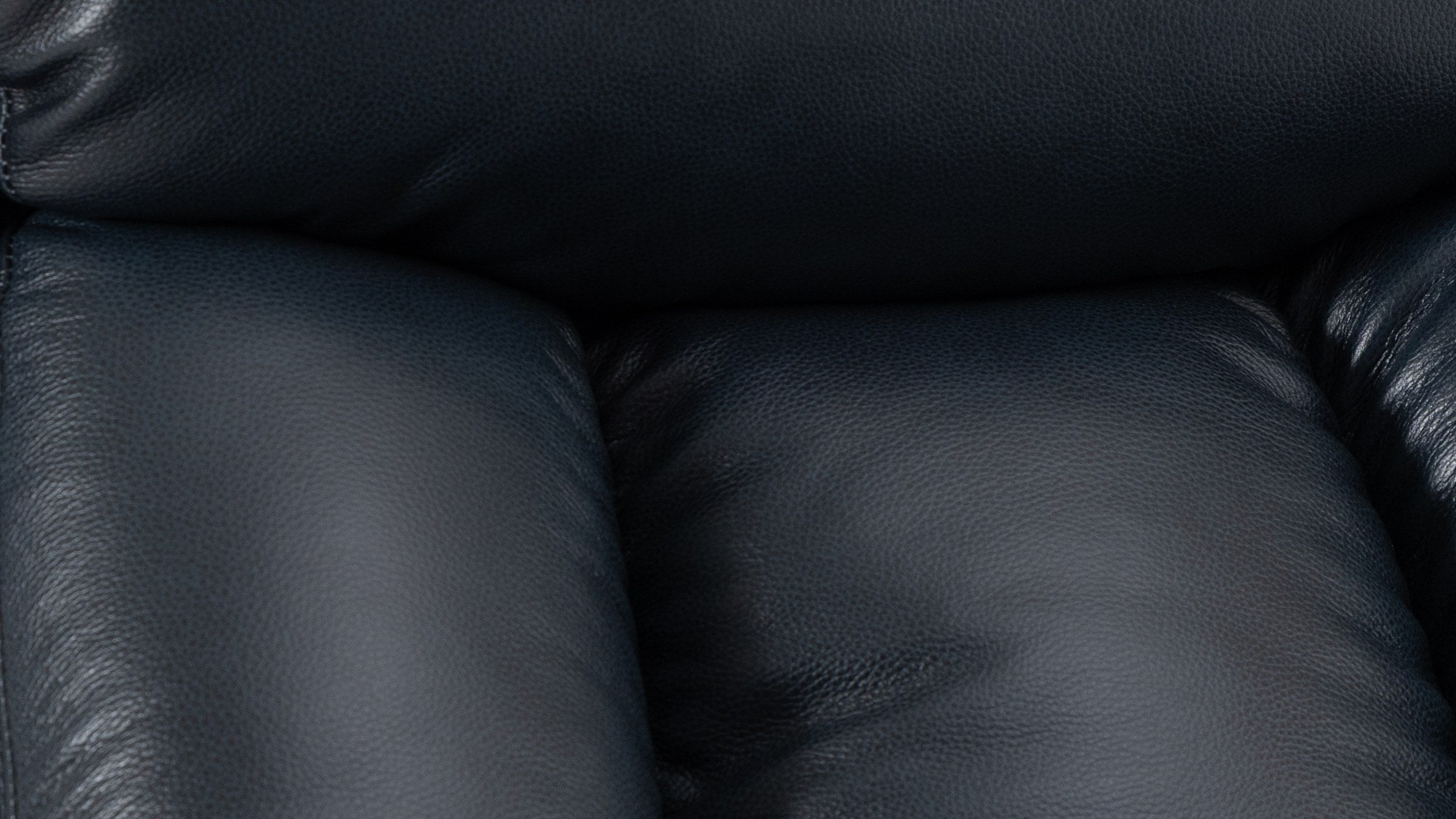 Close-up of the dark blue top grain leather on the Irene House 9185 small lift recliner, showing the natural grain