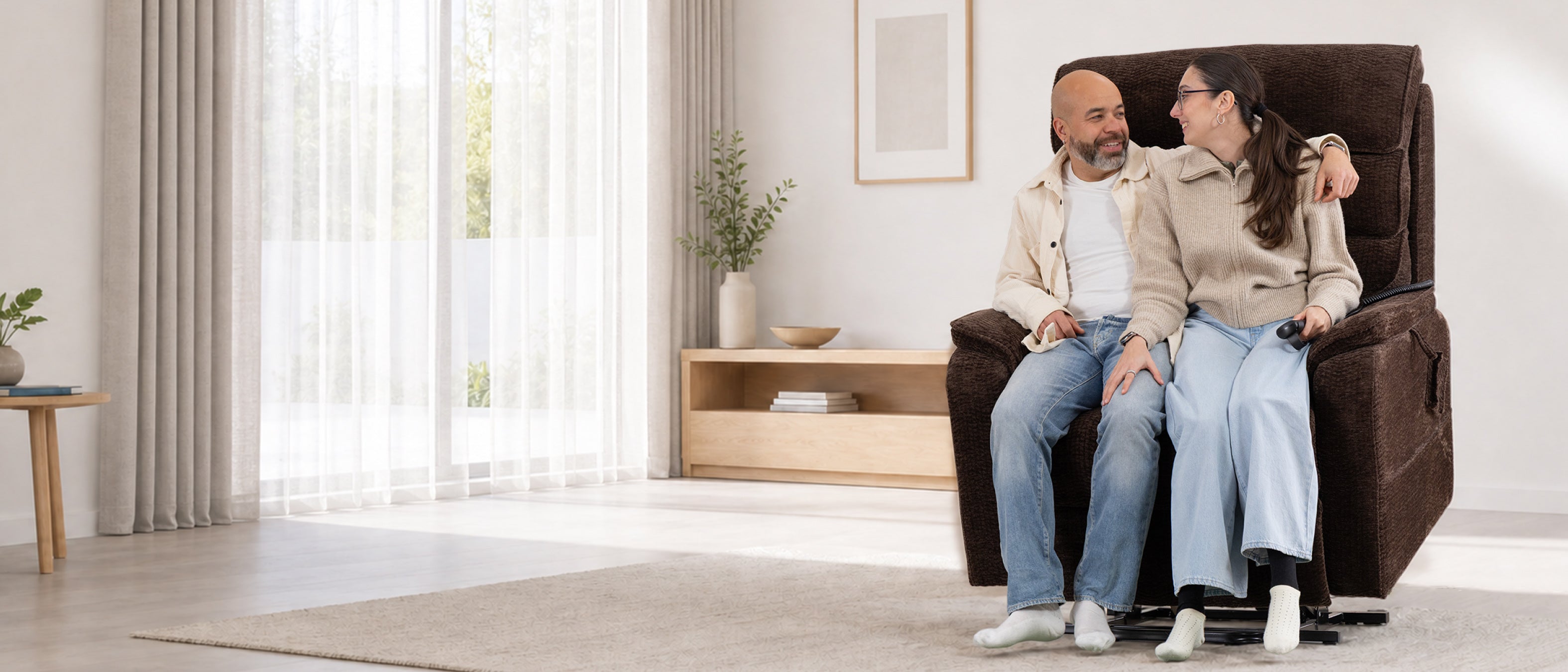 A couple sitting together in one Irene House 9188 EWT500 heavy duty lift recliner in dark brown chenille, showing the extra-wide 30.5 inch seat