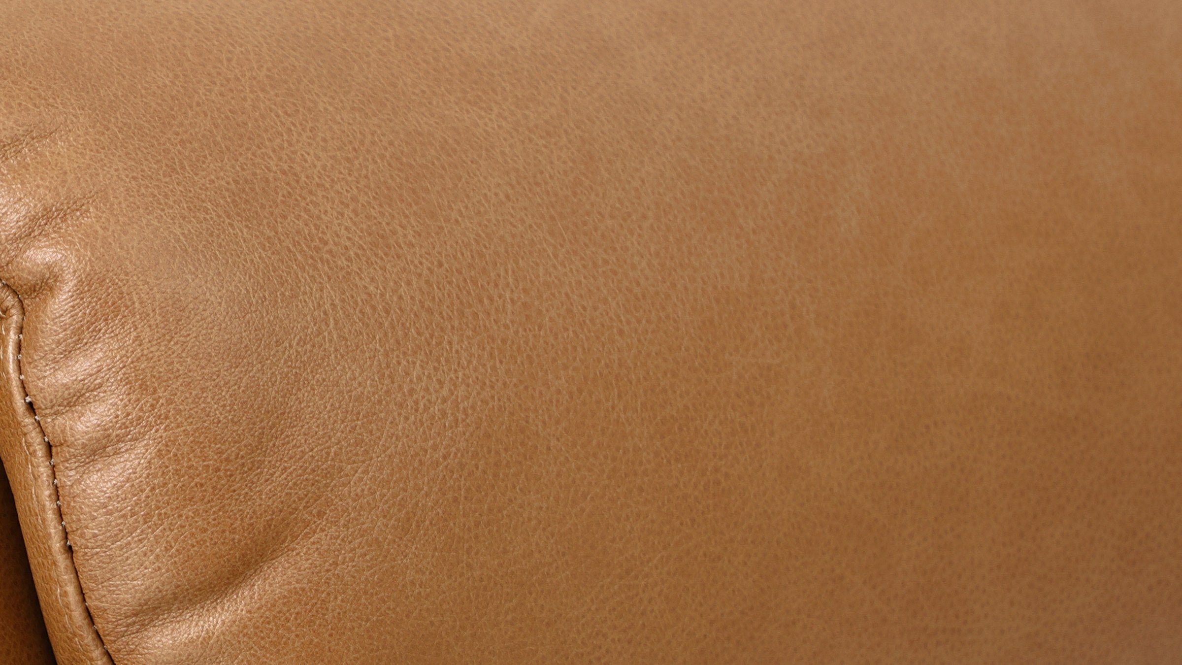 Close-up of the camel brown top grain leather on the Irene House 9185 small lift recliner, showing the natural grain