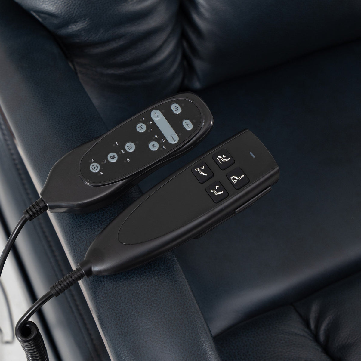 The two Irene House 9185 hand controls — position control and heat and massage control — on the dark blue leather seat