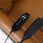 The two Irene House 9185 hand controls — position control and heat and massage control — on the camel brown leather seat
