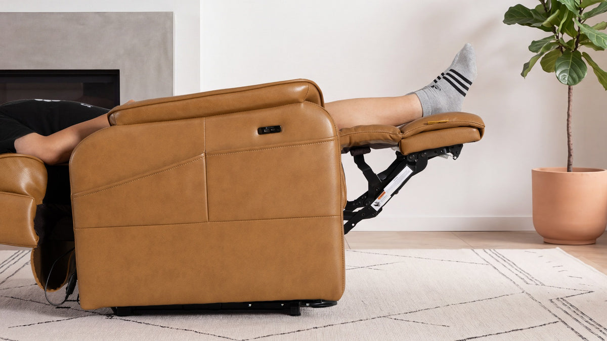 A person lying back in the Irene House 9188E Pro with legs supported on the extendable footrest, raised 7 cm higher than the previous generation