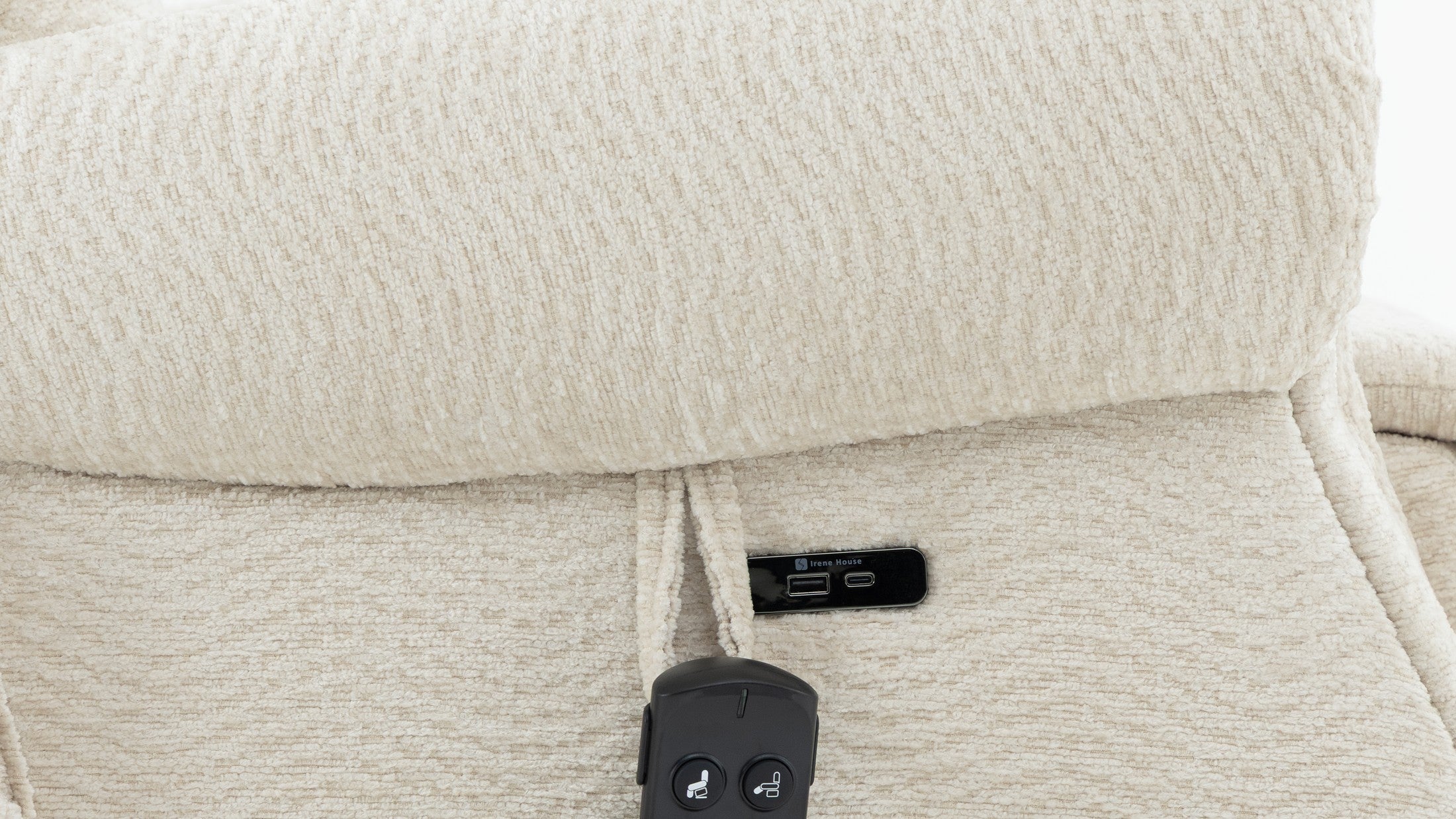 A phone charging from the USB port in the side panel of the Irene House 9199 cream chenille recliner