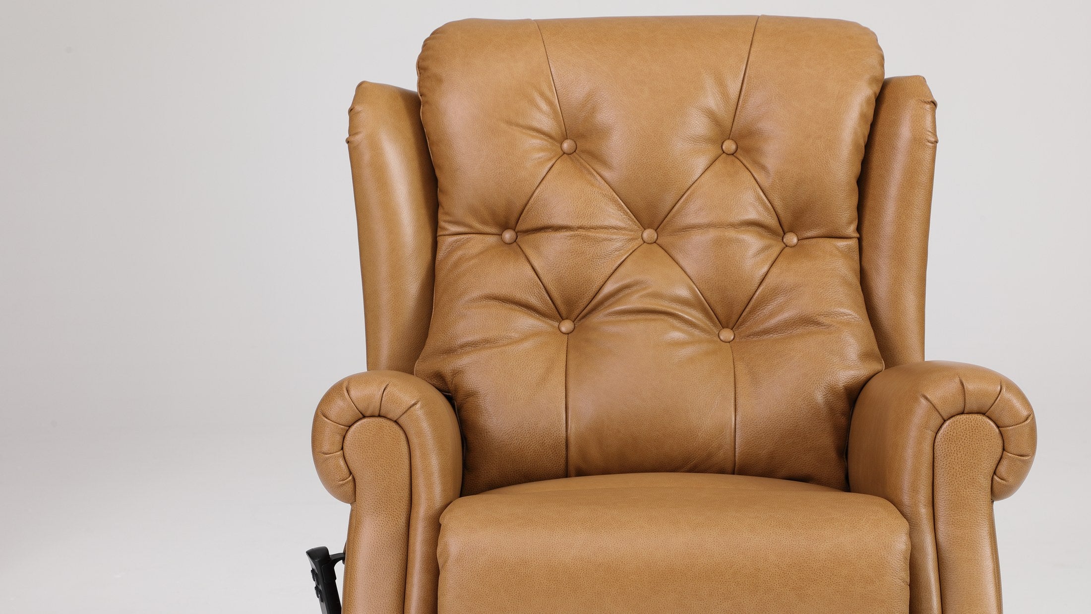 Close-up of the button-tufted camel top grain leather back on the Irene House 9199, showing the diamond pattern and grain