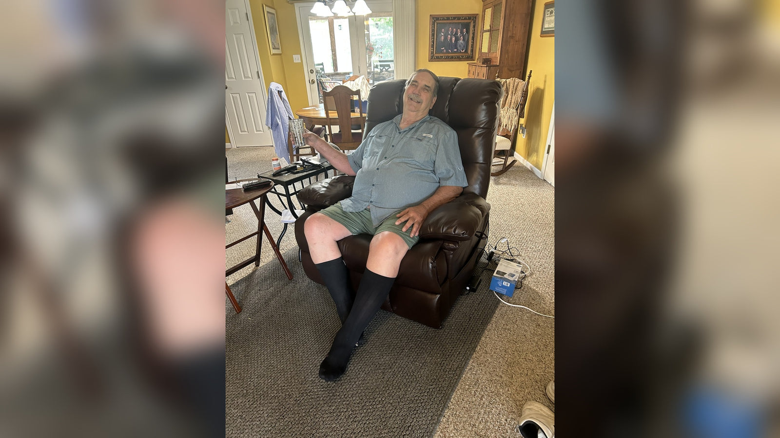 A verified Irene House 9205 owner relaxing in his brown breathable leather big and tall power lift recliner at home — 27.5 inch wide seat, 400 lb capacity, real customer photo